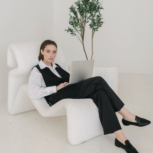 Professional female researcher in elegant attire with confident analytical demeanor