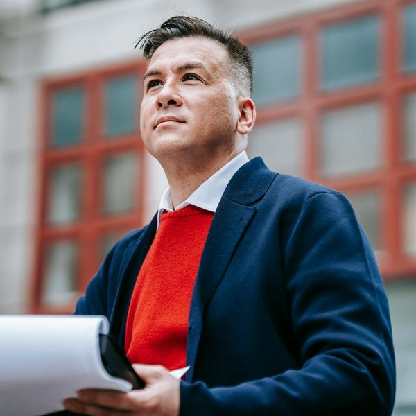 Professional male analyst with confident expression in modern analytical workspace